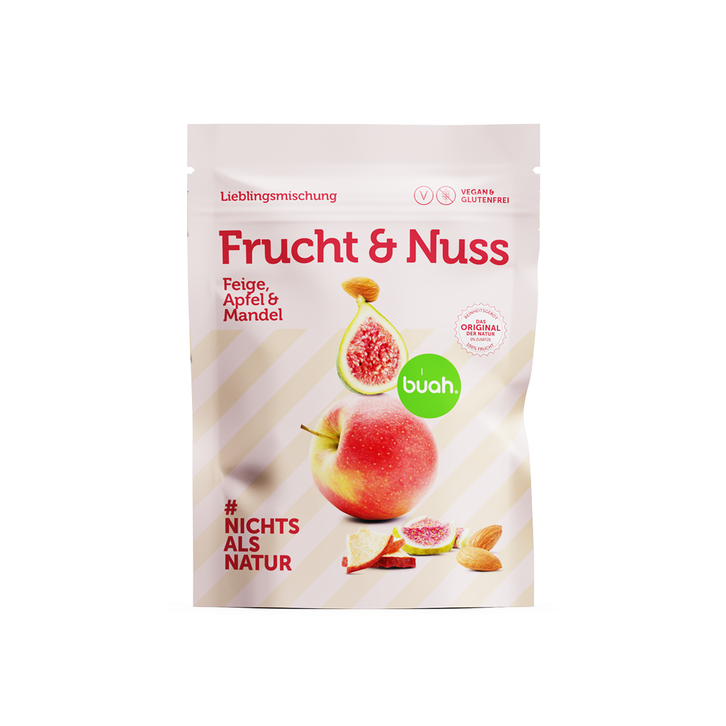 Packung buah Frucht & Nuss Mischung der Sorte Feige, Apfel und Mandel vor rosa Hintergrund
